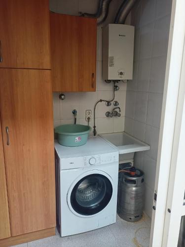 a washing machine with a bowl on top of it at Apartment La Huerta de Beniajan 50 por ciento dcto directo in Murcia