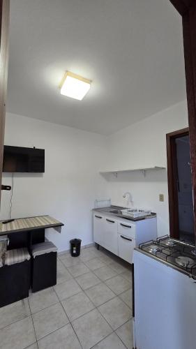 a kitchen with a sink and a stove top oven at Casa até 4 pessoas Rua Corrupiao Bombas in Bombinhas
