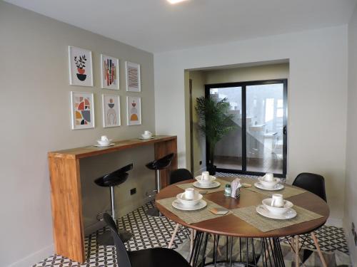a dining room with a table and chairs at Casa Martina Manga Cartagena in Cartagena de Indias