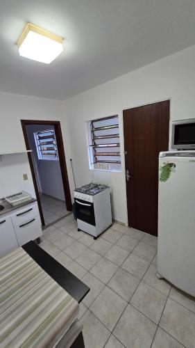 a kitchen with a stove and a refrigerator at Casa até 4 pessoas Rua Corrupiao Bombas in Bombinhas
