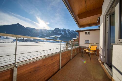 a balcony with a view of the ocean and mountains at Hotel Garni Tirol in Walchsee