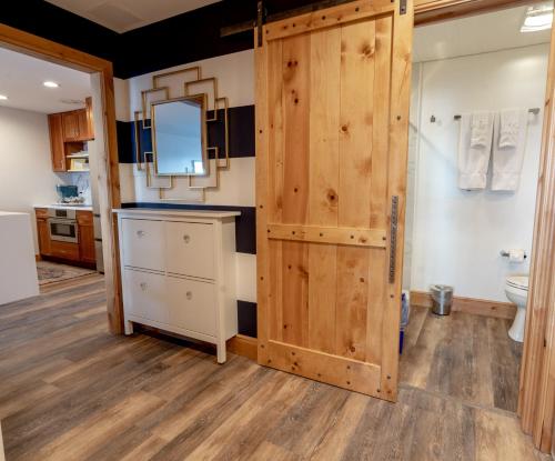 a bathroom with a wooden door and a toilet at Treasure Mountain Inn in Park City