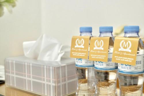 a group of bottles of water sitting on a table at Kim Minh Apartment & Hotel in Vung Tau