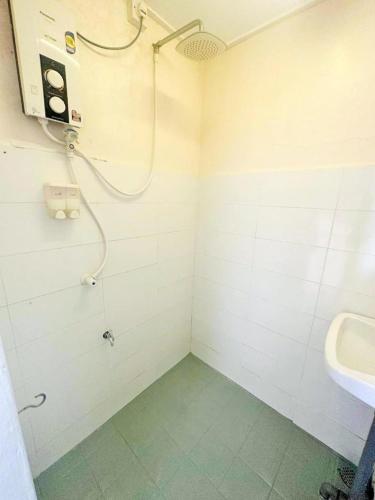 a bathroom with a shower and a sink at Jonker Vibe Inn in Malacca