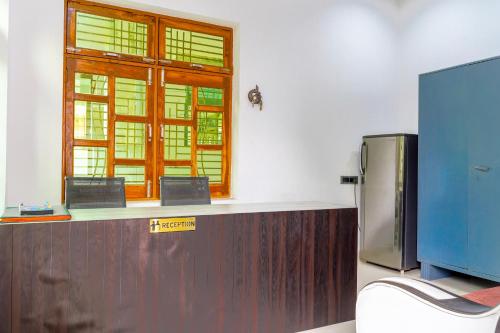 a kitchen with a counter and a window in a room at Usha Residency in Varanasi