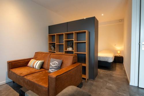 a living room with a couch and a bed at Appartementen De Witte Brugh in Buren