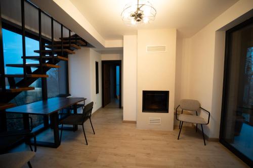 a dining room with a table and chairs and a spiral staircase at EcoTravel New in Suceava