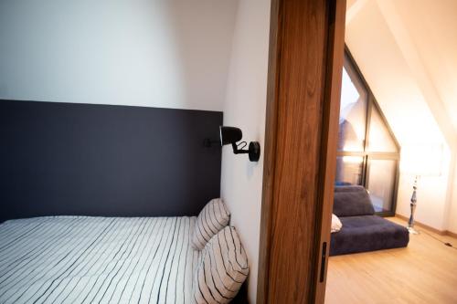 a bedroom with a bed with a black headboard at EcoTravel New in Suceava