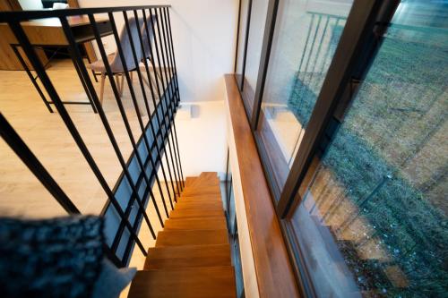 a staircase with a glass window and a stair case at EcoTravel New in Suceava