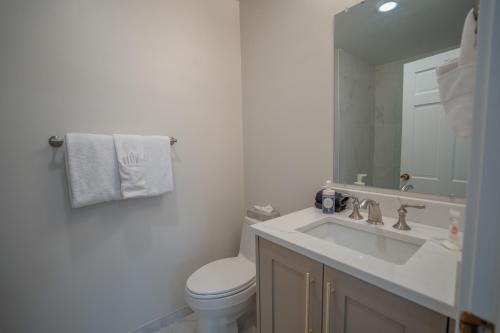 a bathroom with a sink and a toilet and a mirror at Treasure Mountain Inn in Park City