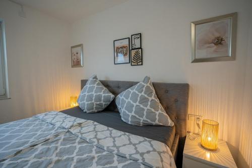 a bedroom with a bed with two pillows on it at Feel like Home 1 in Biberach an der Riß