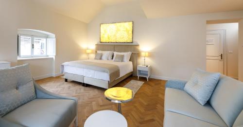 a hotel room with a bed and a couch at Heritage hotel Santa Lucia in Split