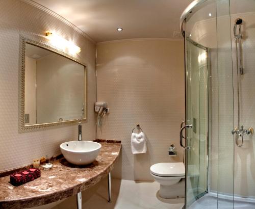 a bathroom with a sink and a toilet and a shower at Kristel Hotel in Saints Constantine and Helena