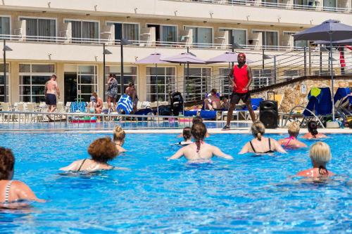a group of people in a swimming pool at Eix Platja Daurada Hotel & SPA in Can Picafort