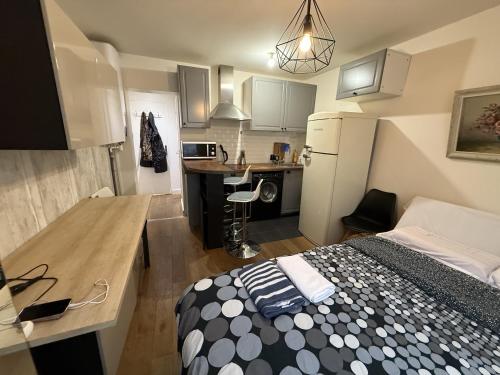 Cette petite chambre comprend un lit et une cuisine. dans l'établissement Studio Chic proche de la tour Eiffel, à Paris