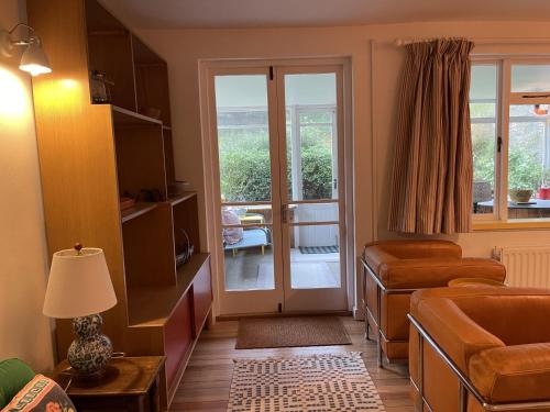 a living room with a door to a balcony at Lynchway in Lyme Regis
