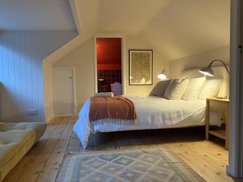 a bedroom with a bed and a couch at Lynchway in Lyme Regis