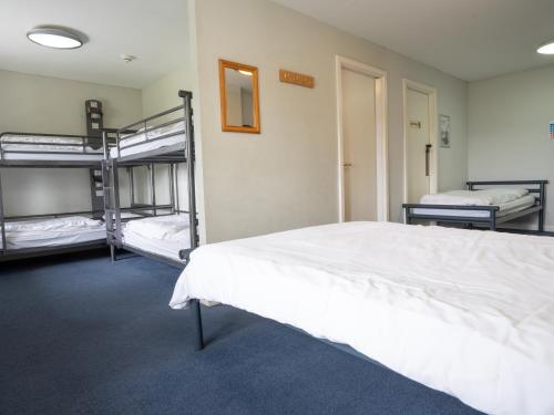 a bedroom with three bunk beds in a room at YHA Whitby in Whitby