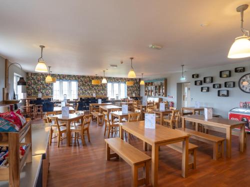 a dining room with wooden tables and chairs at YHA Whitby in Whitby