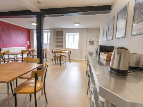 a kitchen and dining room with tables and chairs at YHA Whitby in Whitby