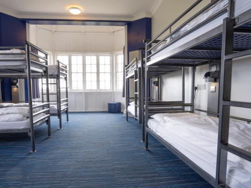 a dorm room with several bunk beds in it at YHA Whitby in Whitby