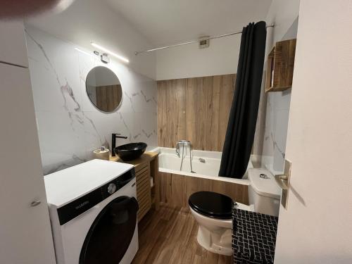 une salle de bain avec toilettes, lavabo et baignoire dans l'établissement le GENEPY, studio 30m2, 4 p, balcon parking, clim, à Fréjus