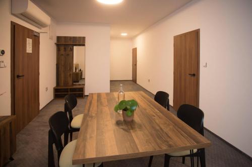 a conference room with a wooden table and chairs at Wellness Hotel Zavadilka in Prostřední Bečva