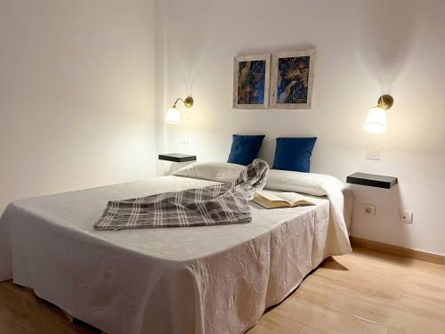 a bedroom with two beds and two lights on the wall at Suites Esencia Atlántica Confort cerca del mar in Telde