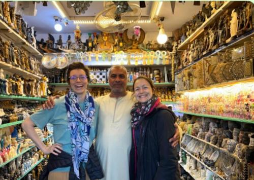 a man and two women standing in front of a store at Osiris Guest House in Abu Simbel