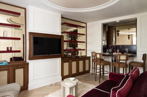 - un salon avec un canapé, une télévision et un bar dans l'établissement Sublim apartment with AC next to Arc de Triomphe, à Paris