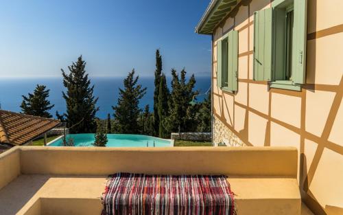 a view from the balcony of a house with a swimming pool at melivaro villa in Tsoukaladhes