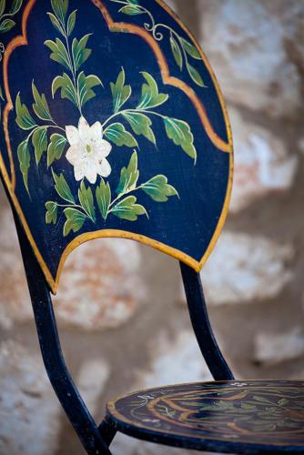 a blue chair with a flower painted on it at melivaro villa in Tsoukaladhes
