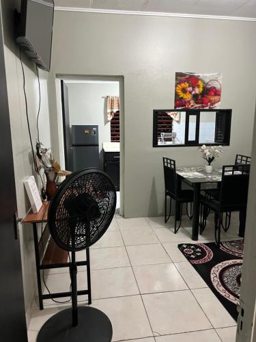 a kitchen and dining room with a table and chairs at Netfa's Hidden Gem in Kingston