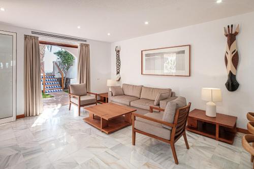 a living room with a couch and a table at Parque Santiago III Official in Playa de las Americas
