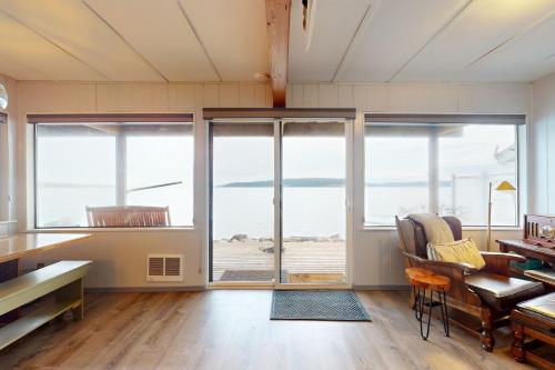 a room with large windows and a desk and chairs at Eastpoint Escape in Langley