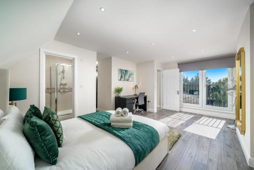 a bedroom with a large white bed and a large window at Spacious Boutique 2 Bed Apartment Retreat Flexi BM in Finchley