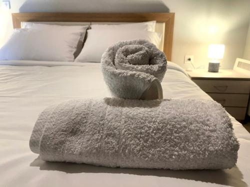 a towel sitting on top of a bed at Dimitris Apartment near Athens Airport in Áyios Spirídhon
