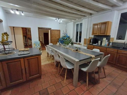 a large kitchen with a large table and chairs at grande maison à la ferme in Neuville-lès-Decize