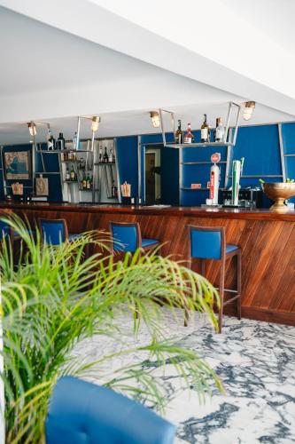a bar on a cruise ship with blue chairs at Marina Club Lagos Resort in Lagos