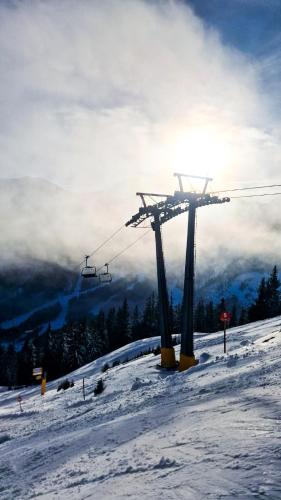 a ski lift on top of a snow covered slope at House of BaRanGo in Präbichl