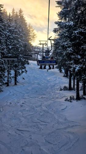 a ski lift with people on it in the snow at House of BaRanGo in Präbichl