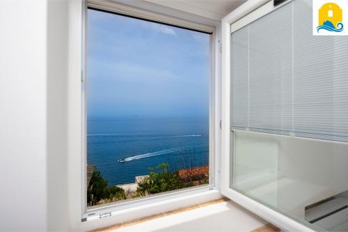a window with a view of the ocean at Casa Angelie in Praiano