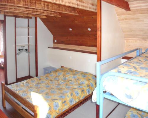 a bedroom with two bunk beds and a staircase at Chalet charmant au Tholy avec piscine partagée in Le Tholy