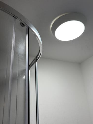 a light on a ceiling with a shower at Home away Tamworth Staffordshire 4 Bedroom 3 Bathroom - Semi Detached House in Glascote