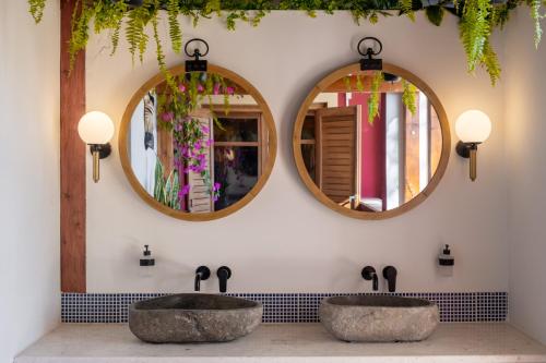 two sinks in a bathroom with two mirrors at Arapaki Secret Garden, Ground Floor 2-bed Deluxe Suite, Private Pool & Sea View in Vournikás