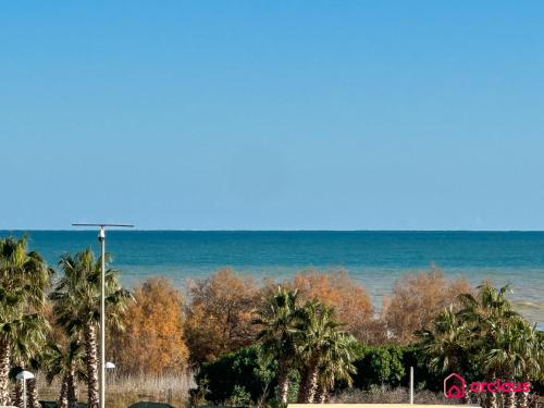 a view of the ocean and palm trees at Brisa Azul in Cabanes