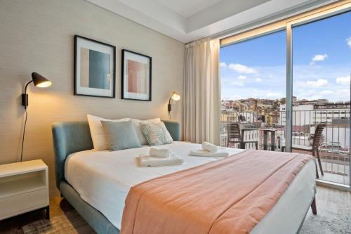 a bedroom with a large bed and a large window at Santos Luxury Studio and Gym V in Lisbon