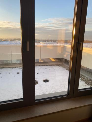 a window with a view of a snow covered yard at Hotel TheGreen in Cologne
