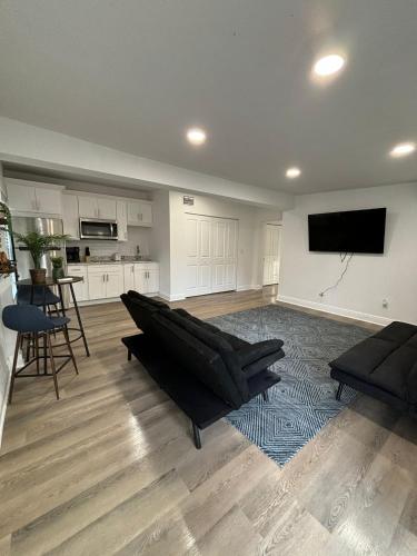 a living room with a couch and a flat screen tv at Cozy 1 Bedroom Duplex in Central Tampa in Tampa