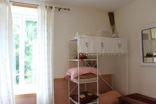 a room with a shelf with someones belongings at Chambres d'hôtes Par Hasard in Saint-Bressou